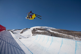 An athlete skiing down a halfpipe